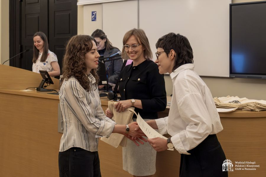 Dwie członkinie jury wręczają nagrody studentce.