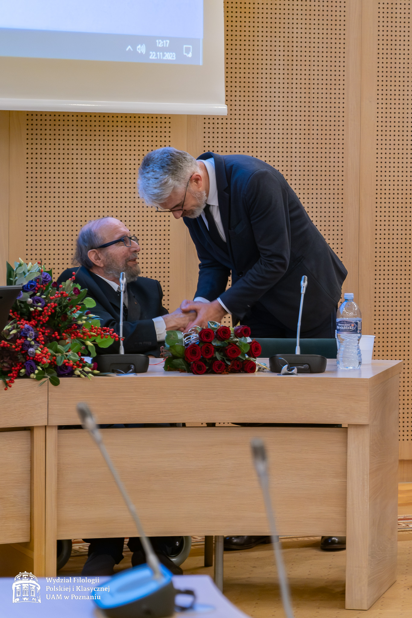 Prof. Jerzy Borowczyk kłania się przed Jubilatem, ściskając mu serdecznie dłoń.