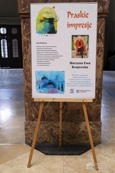 Plakat wystawy stojący na sztaludze.